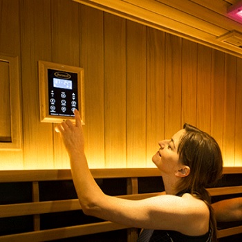 Woman Setting Temperature in Clearlight Infrared Sauna
