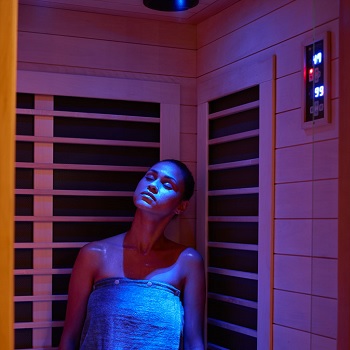 Woman in Sunlighten Signature Sauna with Blue Chromotherapy Light